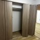 Panasonic VERITISの折れ戸建具で仕上げたクローゼットの施工後写真。ナチュラルな木目調デザインで室内と調和した収納空間。