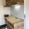 東京都大田区の賃貸マンションで施工したシステムキッチンリフォーム後の様子。クリナップ『ラクエラ』シリーズを採用し、木目調の扉とホワイトパネルで明るく温かみのある空間に生まれ変わった状態。